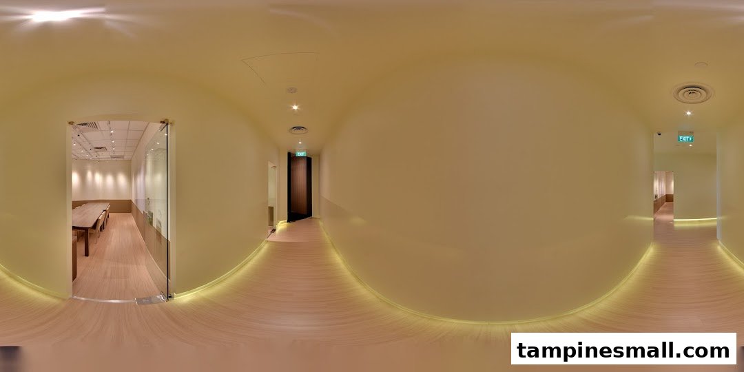 A bright, modern interior hallway of The Learning Lab with visible classrooms and warm lighting.