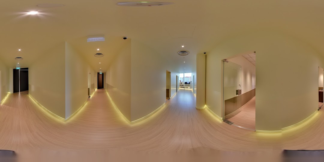 A bright, modern interior hallway with wooden floors and subtle lighting at The Learning Lab.