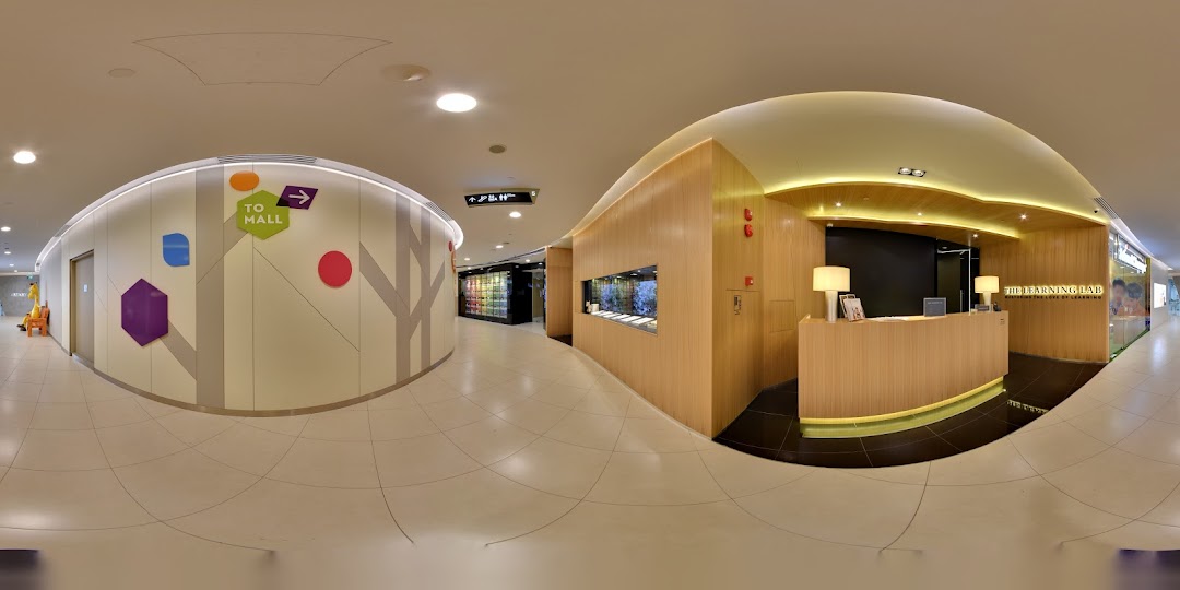 A panoramic view of The Learning Lab's modern reception area and entrance within Tampines Mall.