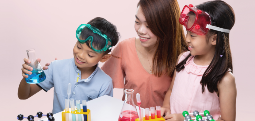 Children and an instructor engaged in a fun science experiment with lab equipment.