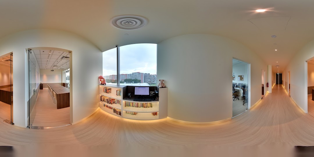 A bright, modern interior of an educational center featuring classrooms, a study area, and a long hallway.