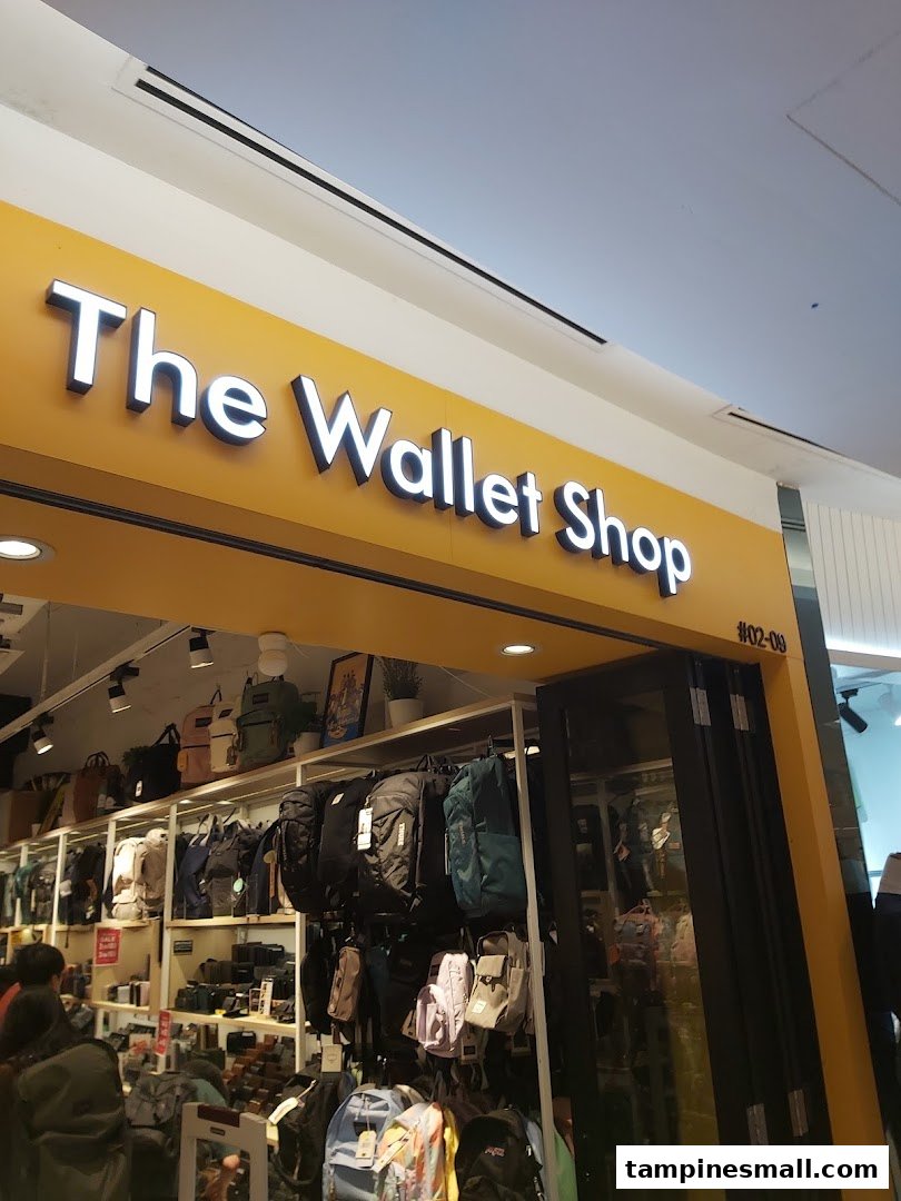 The bright yellow storefront of The Wallet Shop, showcasing a wide array of wallets and bags.