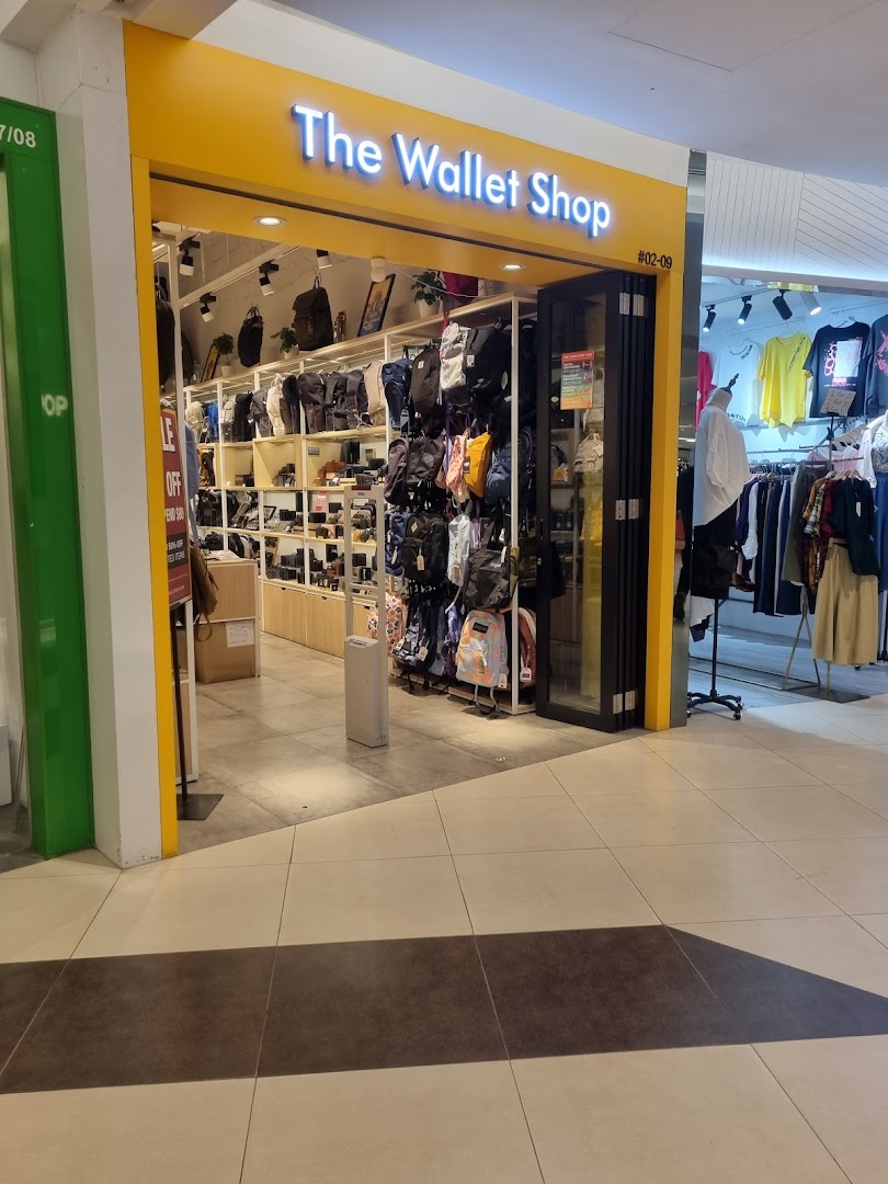 The brightly lit entrance of The Wallet Shop, showcasing a wide array of bags and wallets inside.