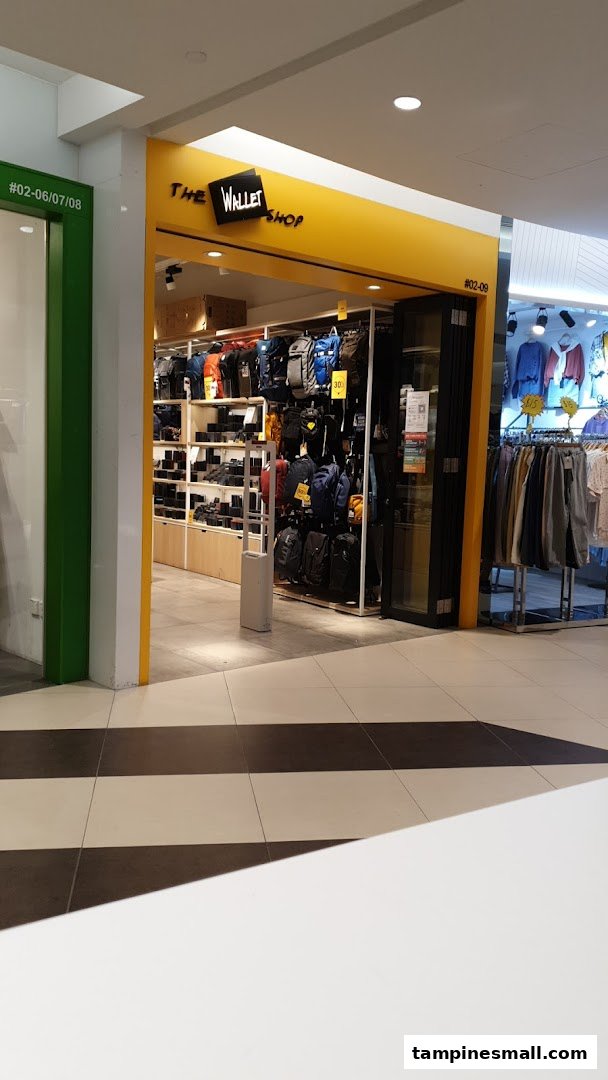 The shopfront of 'The Wallet Shop' showcasing a wide array of wallets, bags, and accessories.