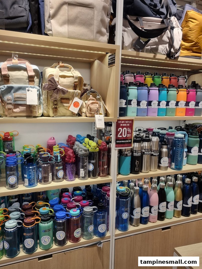 Shelves displaying a wide variety of colorful water bottles and stylish bags inside a retail store.
