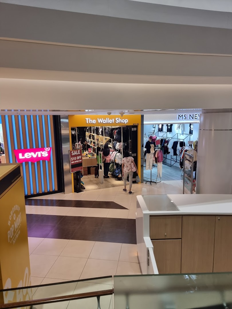 View of The Wallet Shop entrance, showcasing a wide array of wallets and accessories inside.