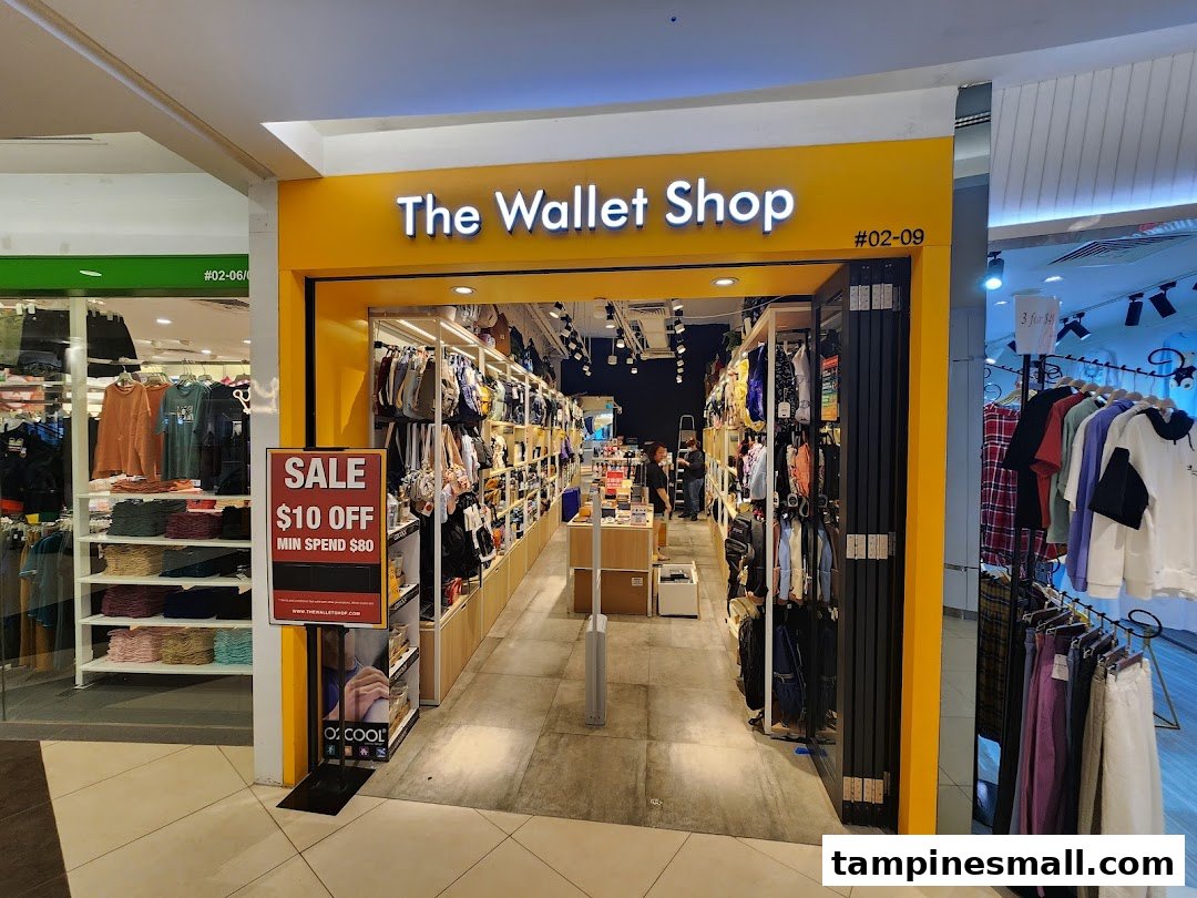 The brightly lit entrance of The Wallet Shop, showcasing a sale promotion and various bags and accessories.