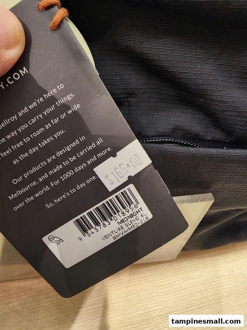 Close-up of a Bellroy Venture Sling product tag displaying price and item details.