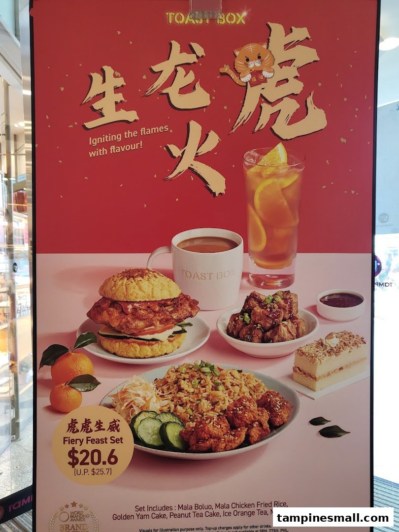 A vibrant promotional poster for Toast Box's 'Fiery Feast Set' featuring various dishes and drinks.
