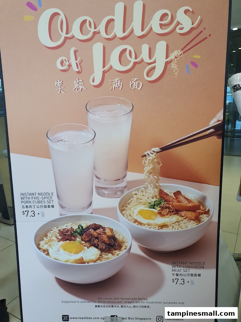 A promotional poster for Toast Box featuring instant noodle sets with pork cubes and luncheon meat, served with barley.