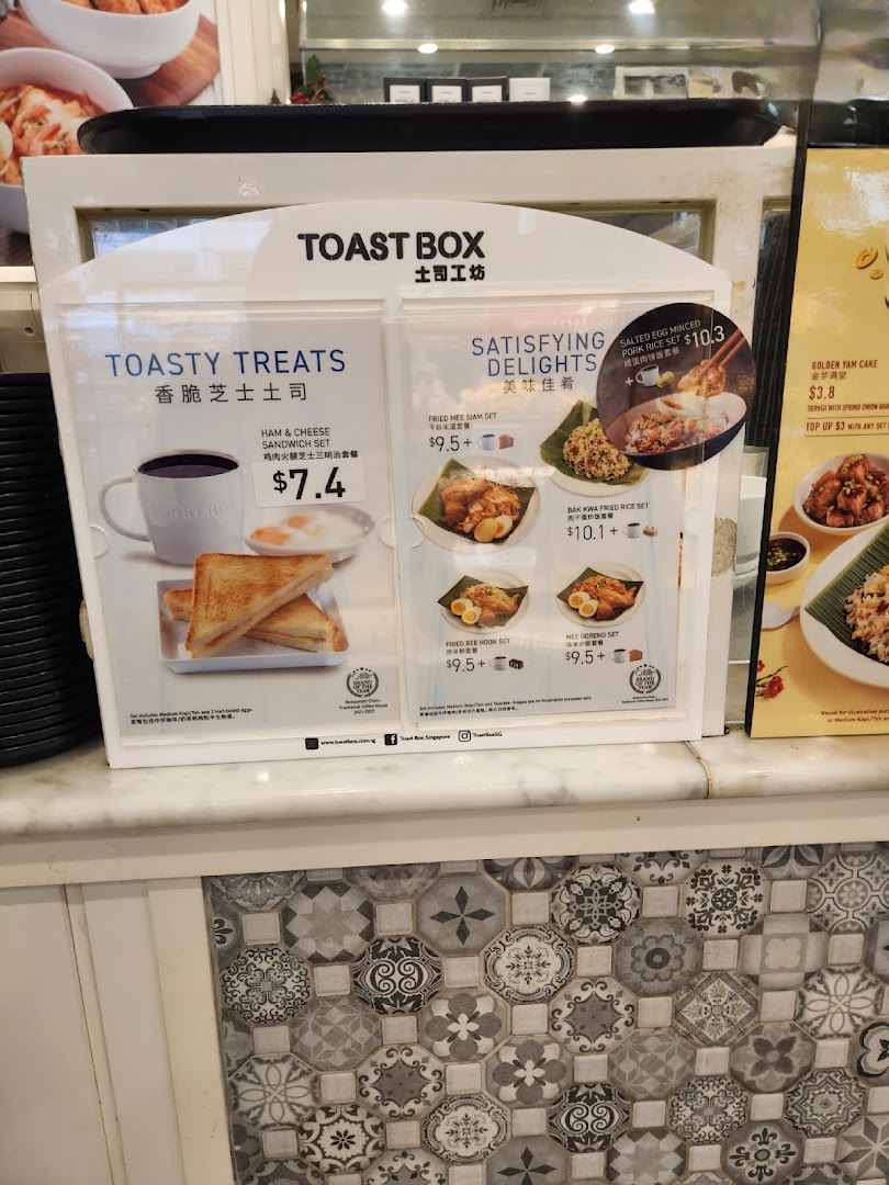 A menu display board showcasing Toast Box's 'Toasty Treats' and 'Satisfying Delights' offerings.