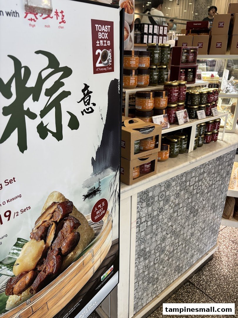 A Toast Box display featuring a Zongzi promotional poster and shelves stocked with various spreads and jams.