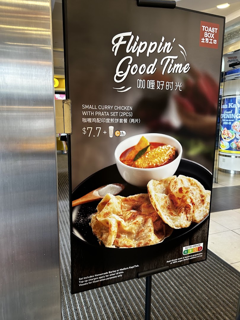 A promotional standee for Toast Box featuring a Small Curry Chicken with Prata Set.