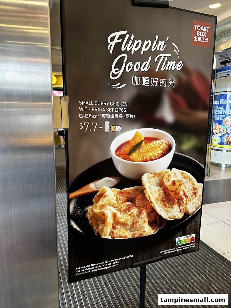 A promotional standee for Toast Box featuring a Small Curry Chicken with Prata Set.