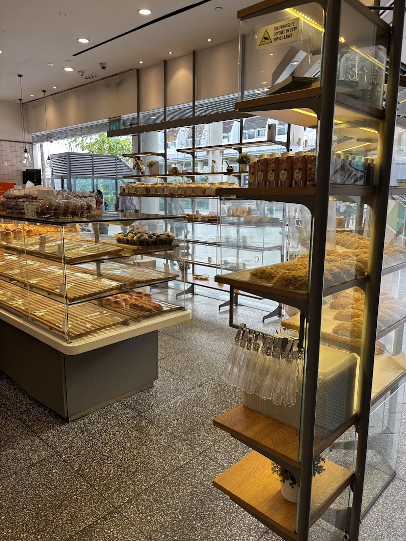 Interior view of Toast Box, showcasing display shelves with pastries and a bright, open layout.
