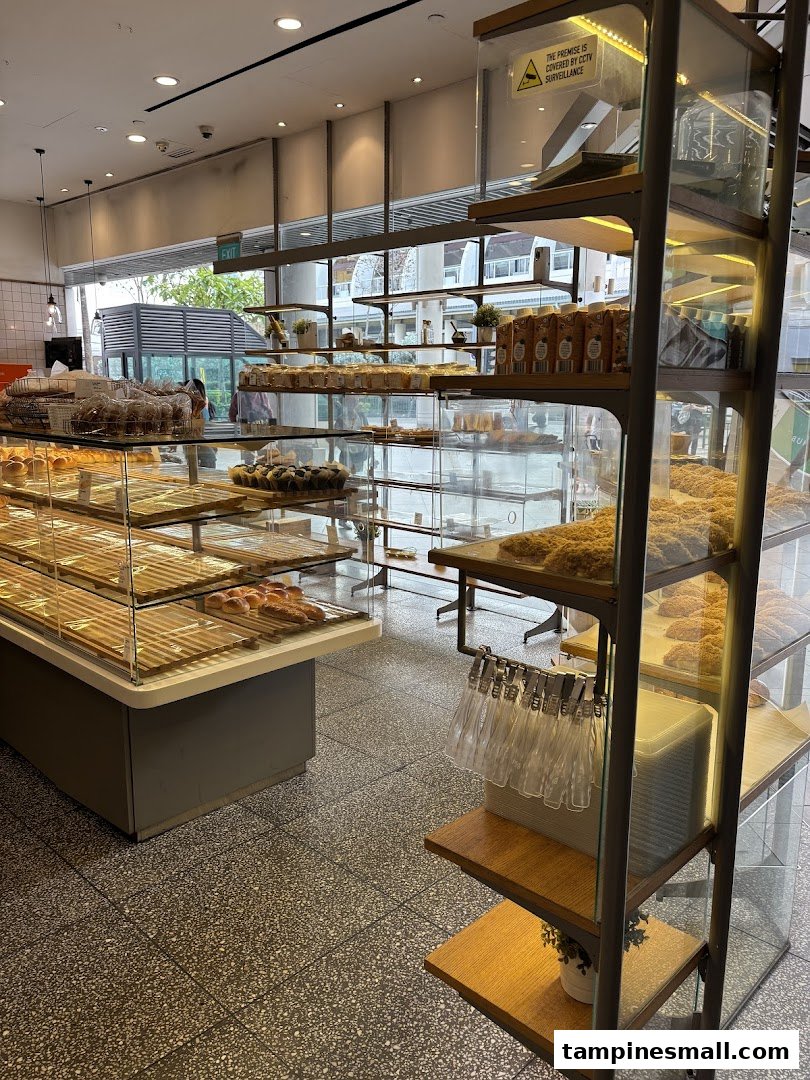 Interior view of Toast Box, showcasing display shelves with pastries and a bright, open layout.