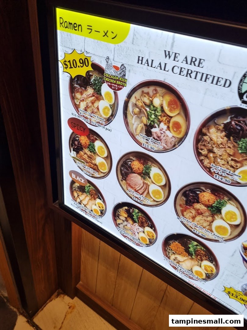 A brightly lit menu board displaying various ramen dishes with prices and a 'Halal Certified' sign.