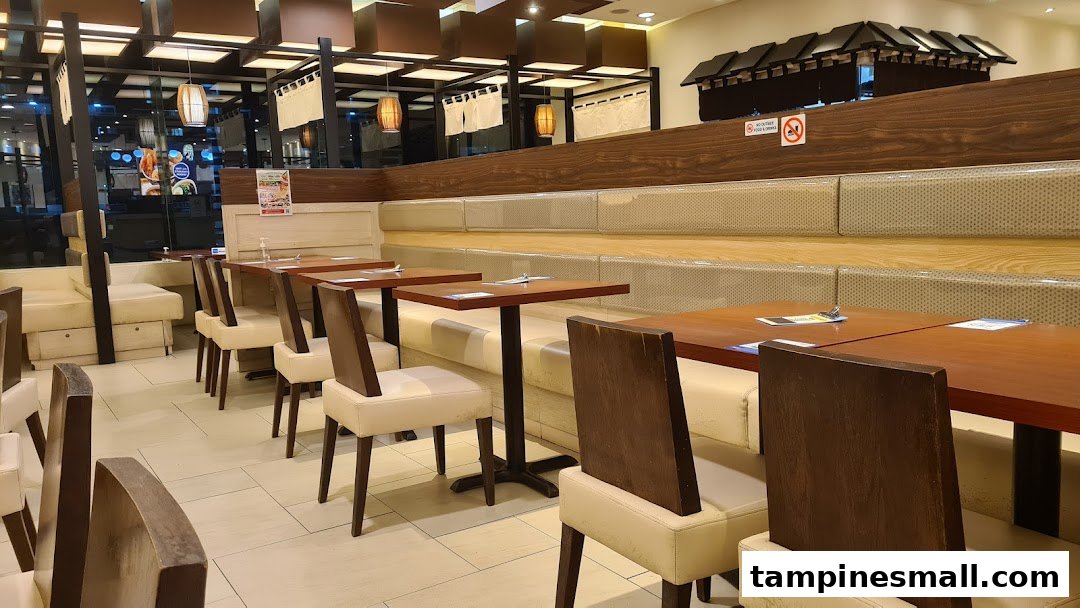 A clean and inviting dining area with wooden tables, comfortable seating, and Japanese-inspired decor.
