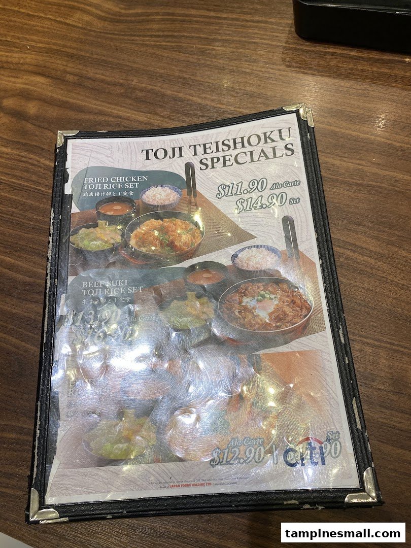 A close-up of a menu displaying Toji Teishoku Specials with prices and food images.