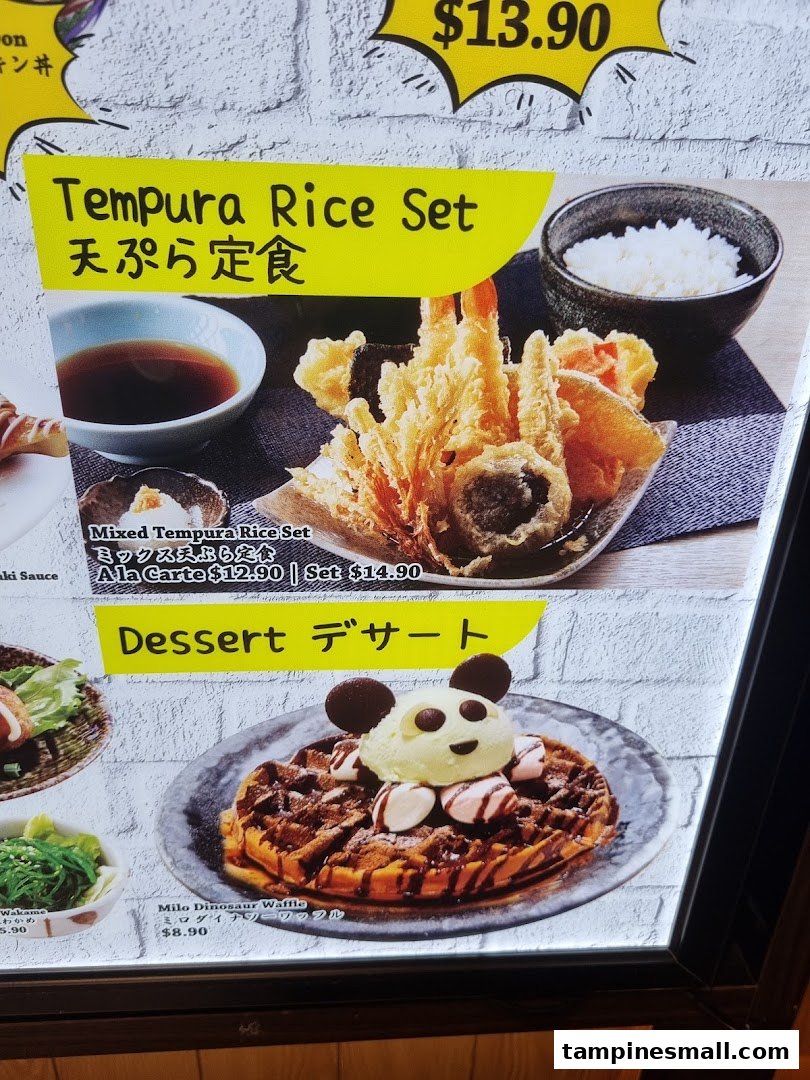 A menu board displaying Japanese tempura rice sets and a whimsical Milo Dinosaur Waffle dessert.