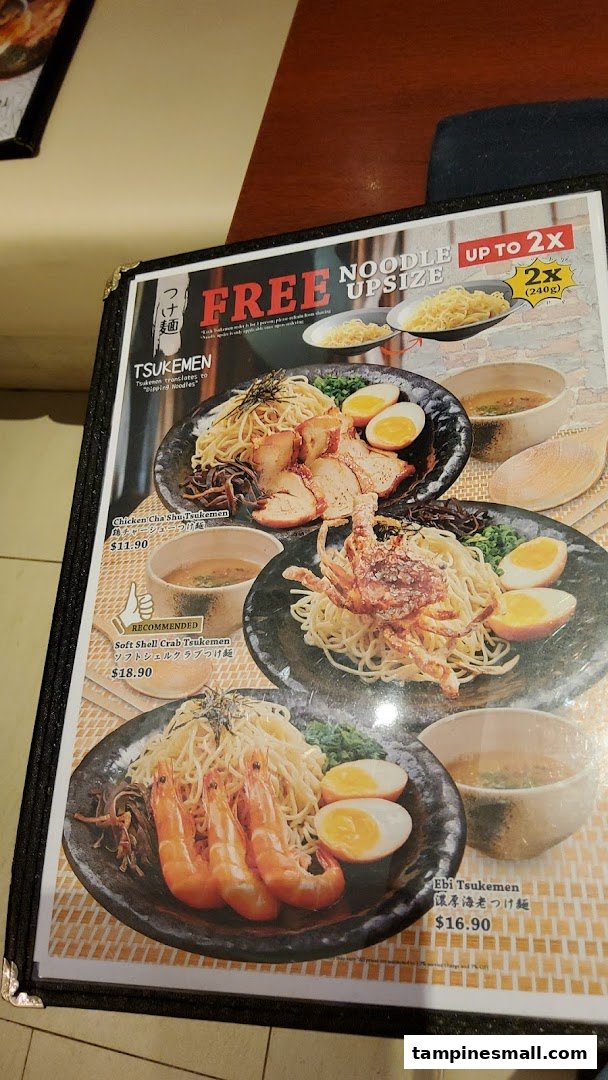 A close-up of a menu page featuring various Tsukemen (dipping noodles) dishes with images and prices.