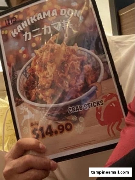 A close-up of a menu page featuring 'Kanikama Don' with a price of $14.90.