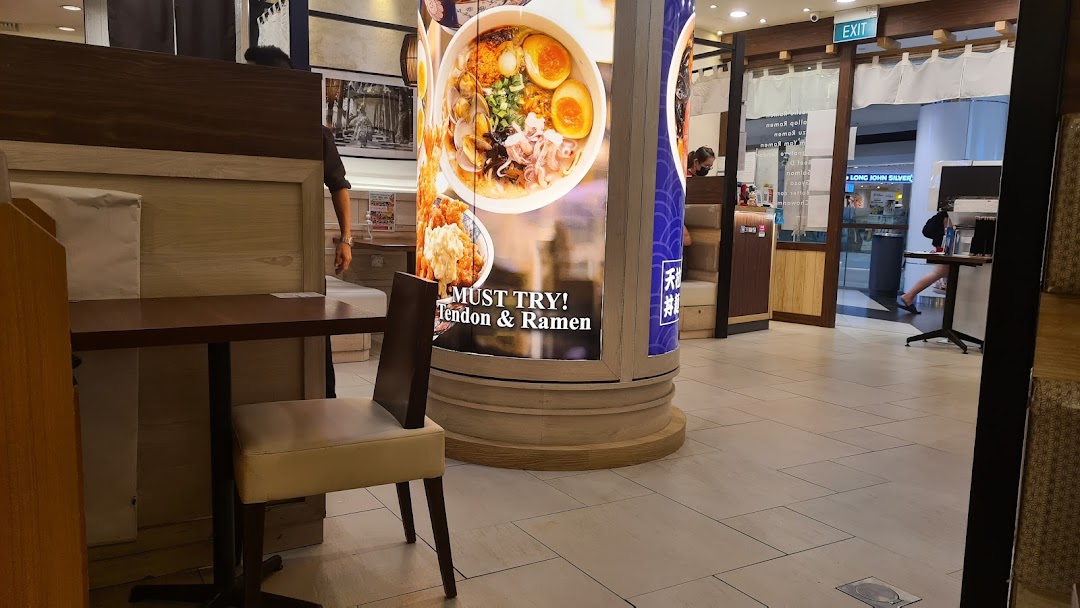Interior view of Tokyo Shokudo, featuring dining tables and a promotional pillar for Tendon and Ramen.