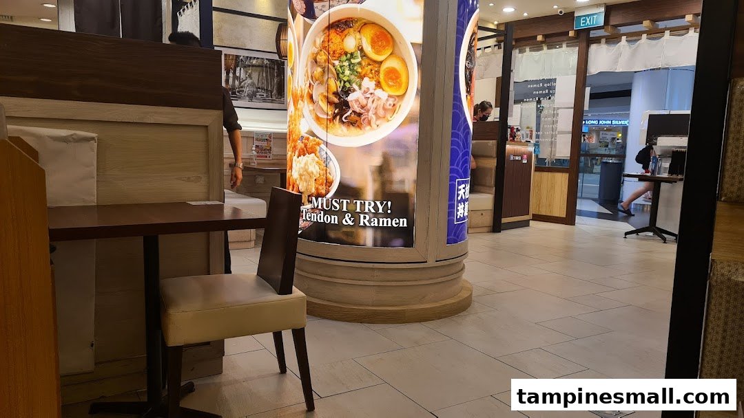 Interior view of Tokyo Shokudo, featuring dining tables and a promotional pillar for Tendon and Ramen.
