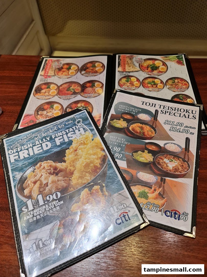 Multiple menu pages displaying various Japanese dishes, including ramen, rice sets, and fried fish.
