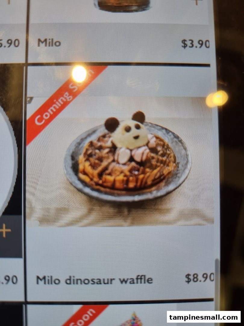 A digital menu displaying Milo beverages and a 'Coming Soon' Milo dinosaur waffle with a cute character design.