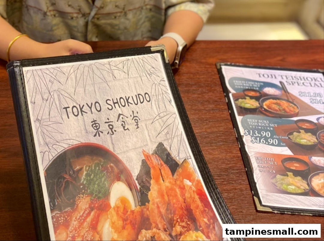 A close-up of a Tokyo Shokudo menu displaying Japanese dishes and prices.
