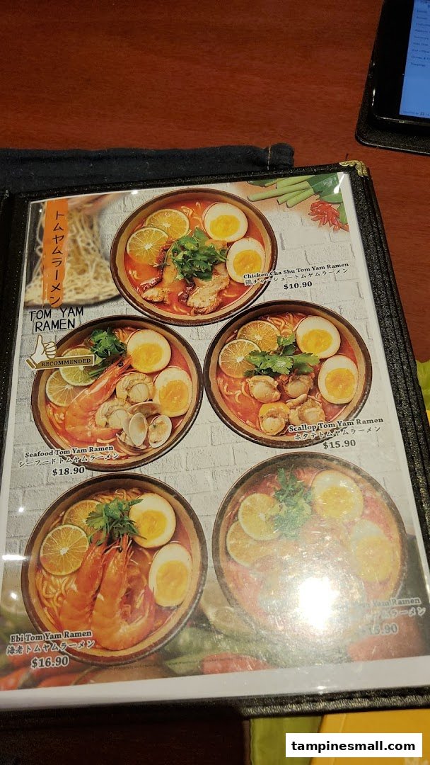 A close-up view of a menu page featuring various Tom Yam Ramen dishes with prices and images.