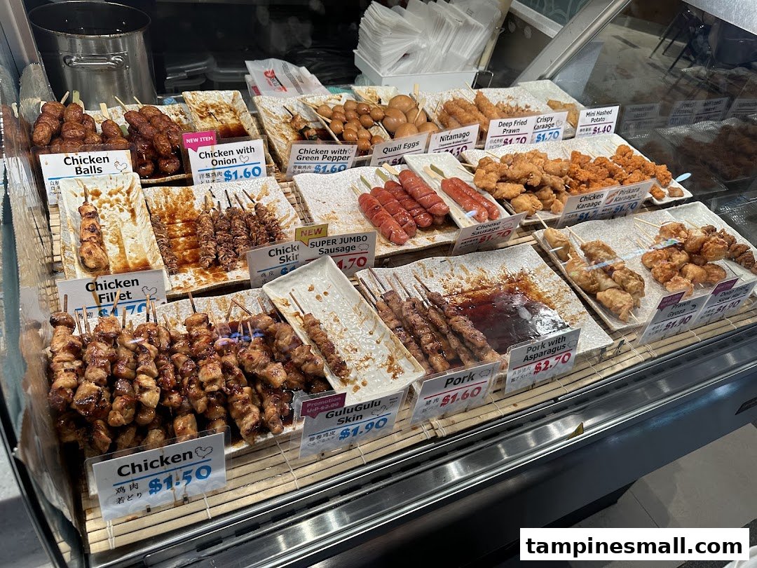 A vibrant display of various Japanese-style skewers and fried items in a retail food counter.