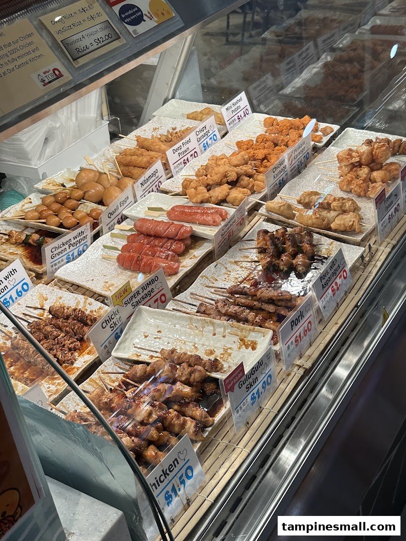 A vibrant display case showcasing a variety of Japanese-style skewers and fried snacks.