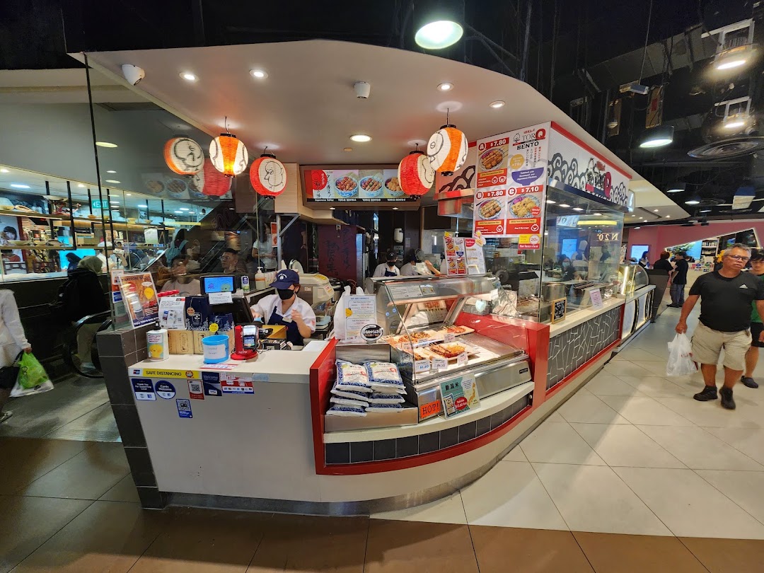 A bustling TORI-Q food stall showcasing its counter, food displays, and staff serving customers.