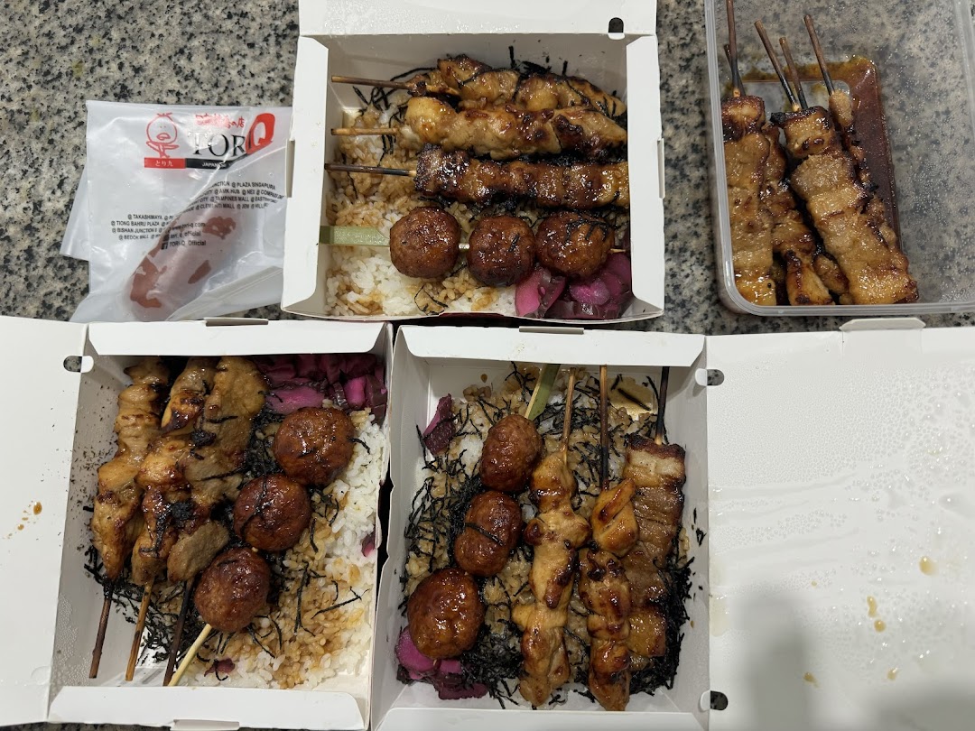 Delicious Japanese yakitori skewers and meatballs served with rice in convenient takeout boxes.