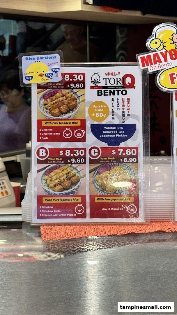 A close-up view of TORI-Q's menu board displaying various bento and value meal options.