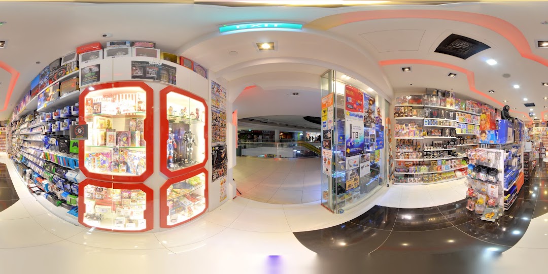 A wide-angle view of the 'Toy Or Game' shop entrance, showcasing product displays and the mall beyond.