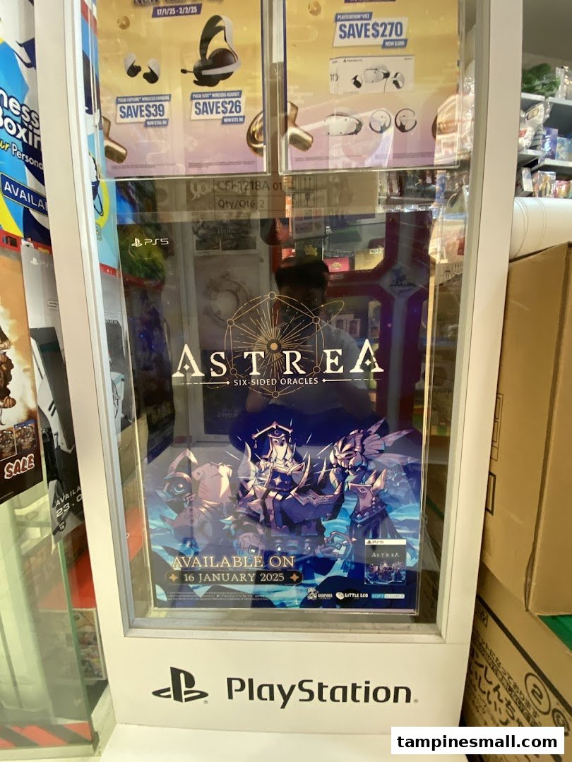 A PlayStation display stand inside a shop, showcasing game promotions and a new game release.