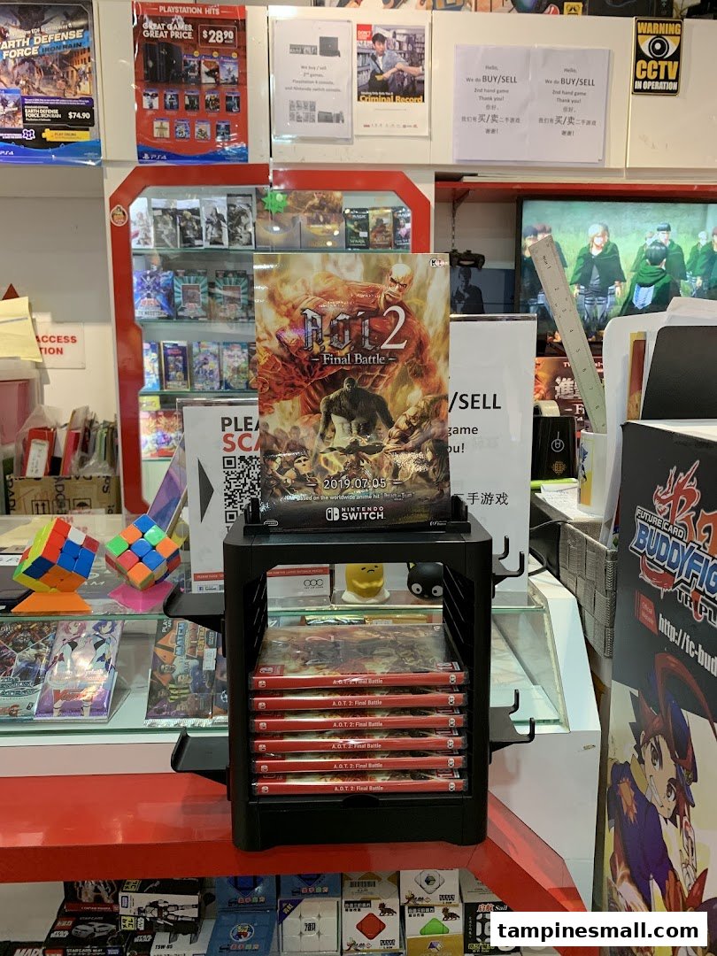 An interior shot of a game and toy shop, featuring video games, Rubik's cubes, and promotional posters.