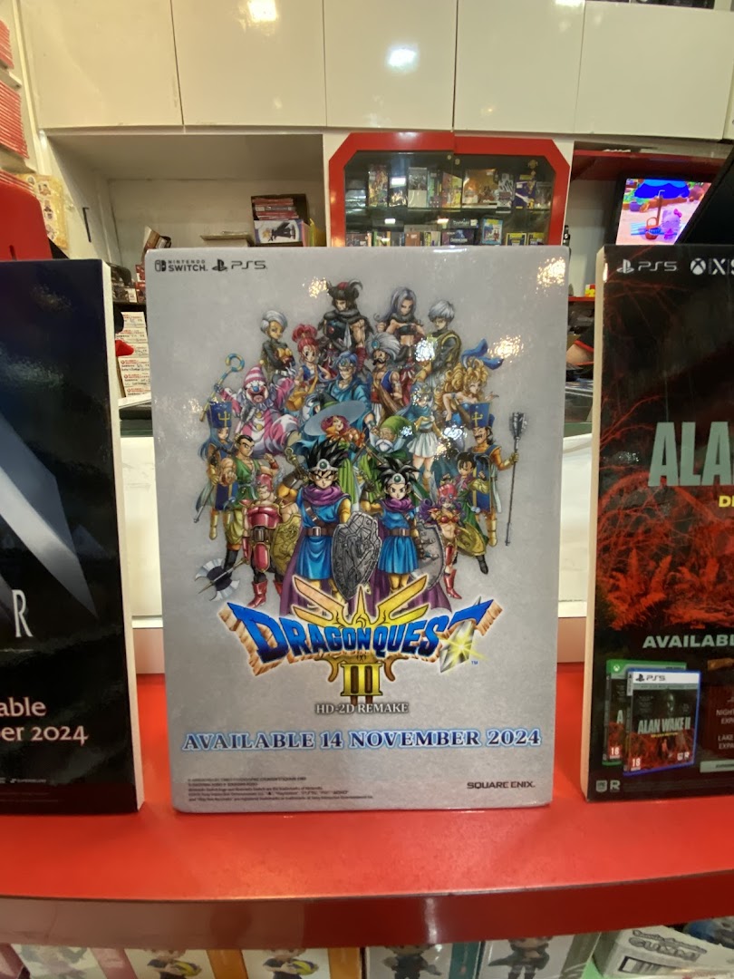 A large display for Dragon Quest III HD-2D Remake game inside a vibrant toy and game shop.