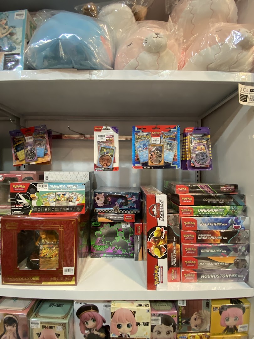 Shelves filled with Pokémon cards, plush toys, and anime figures in a toy and game shop.