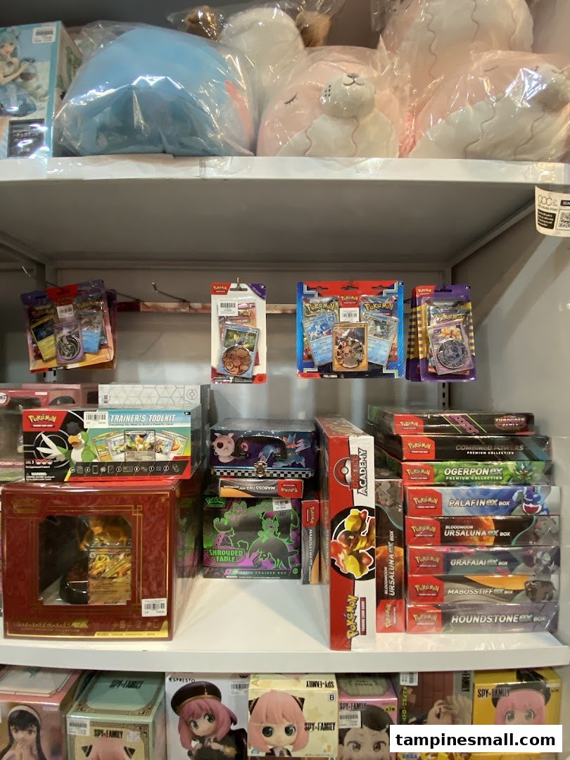 Shelves filled with Pokémon cards, plush toys, and anime figures in a toy and game shop.