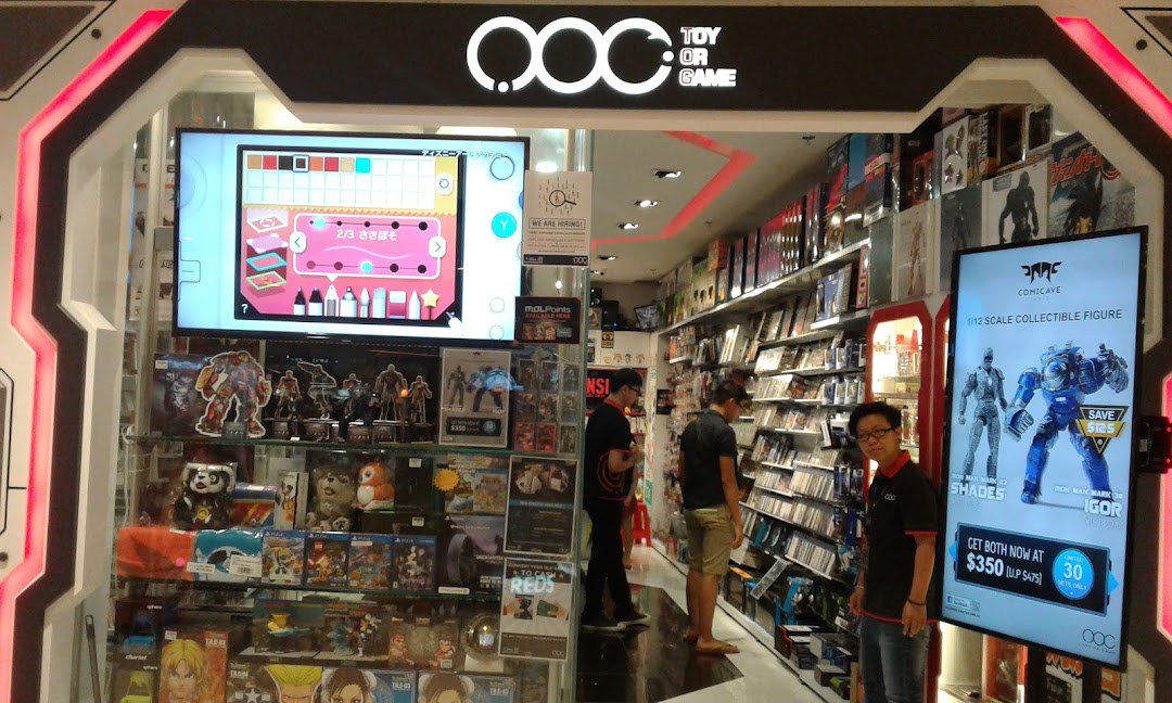 The vibrant entrance of 'Toy Or Game' shop, showcasing collectible figures, games, and a lively interior with customers.