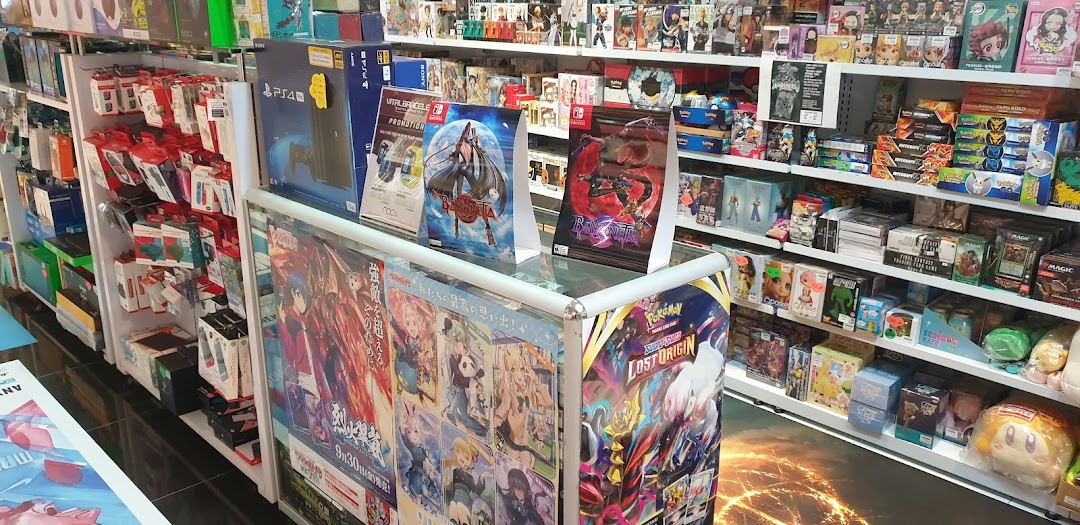 An interior view of 'Toy Or Game' showcasing shelves packed with video games, accessories, trading cards, and various collectibles.