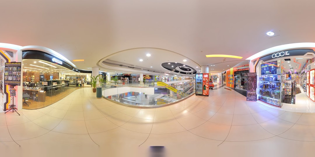 A panoramic view of a brightly lit mall corridor featuring the 'Toy Or Game' shop entrance.