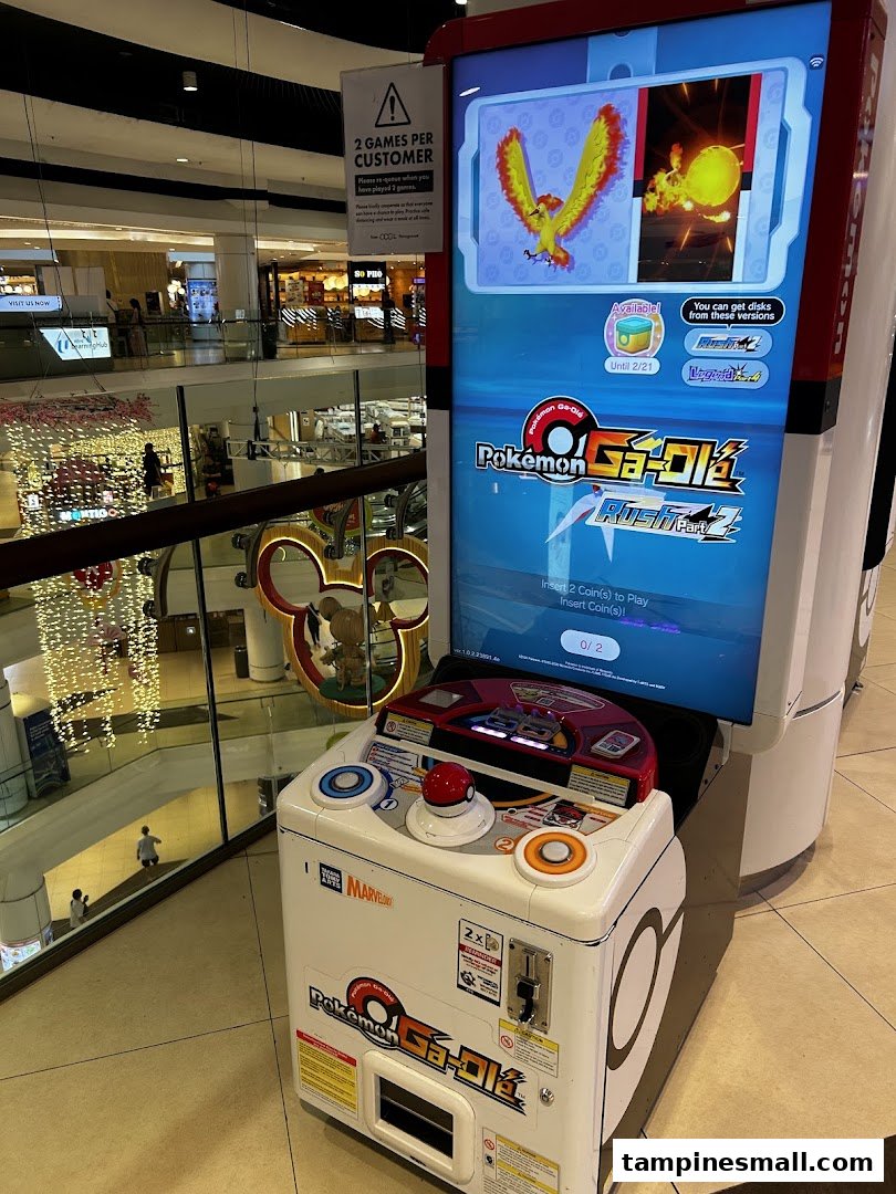A Pokémon Ga-Olé arcade game machine stands ready for play in a bustling shopping mall.