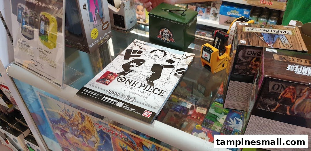 A retail display counter showcasing anime merchandise, card games, and digital bracelets from 'Toy Or Game' shop.