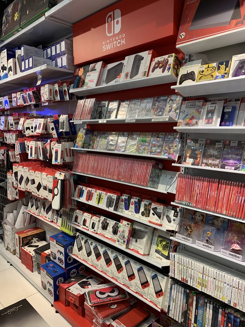 Shelves packed with Nintendo Switch consoles, games, and accessories in a vibrant retail store.