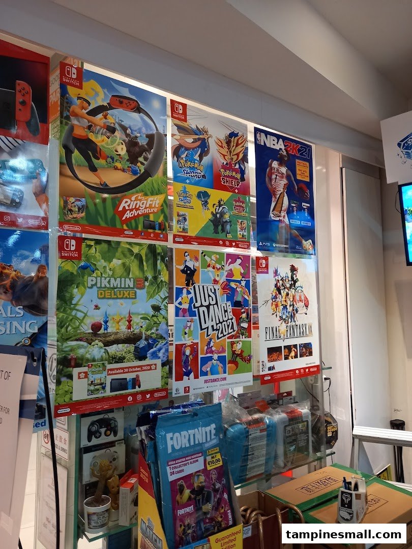 A vibrant display of video game posters and merchandise, including popular titles like Ring Fit Adventure and Fortnite.